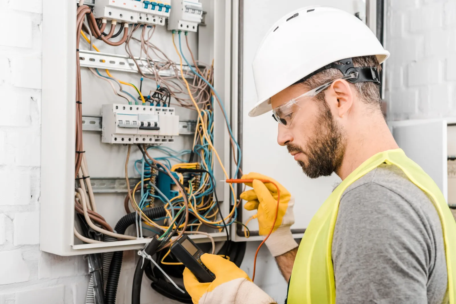 Electrician inspecting a circuit breaker panel