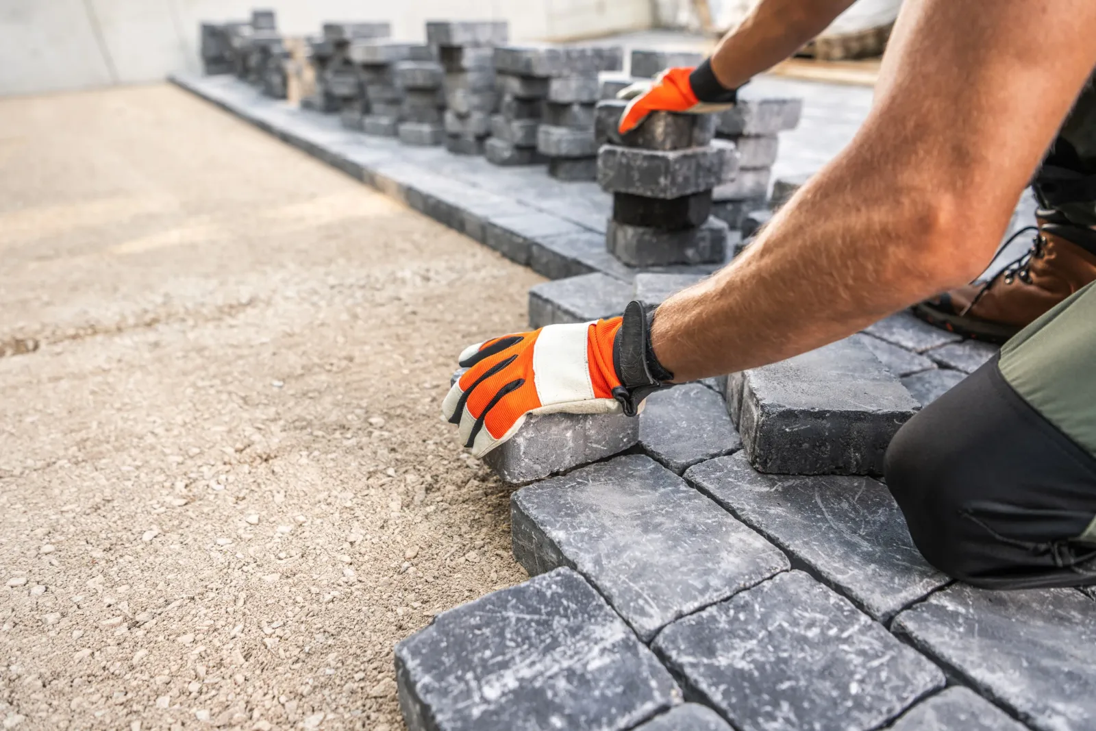A contractor sets outdoor brick tiles.