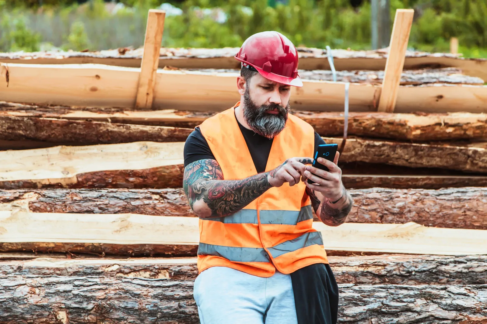 Contractor at a lumber yard using his phone
