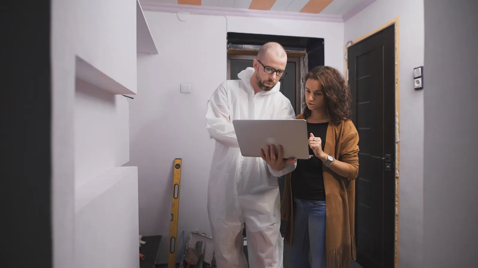 A contractor reviewing an estimate with a client on a job site.