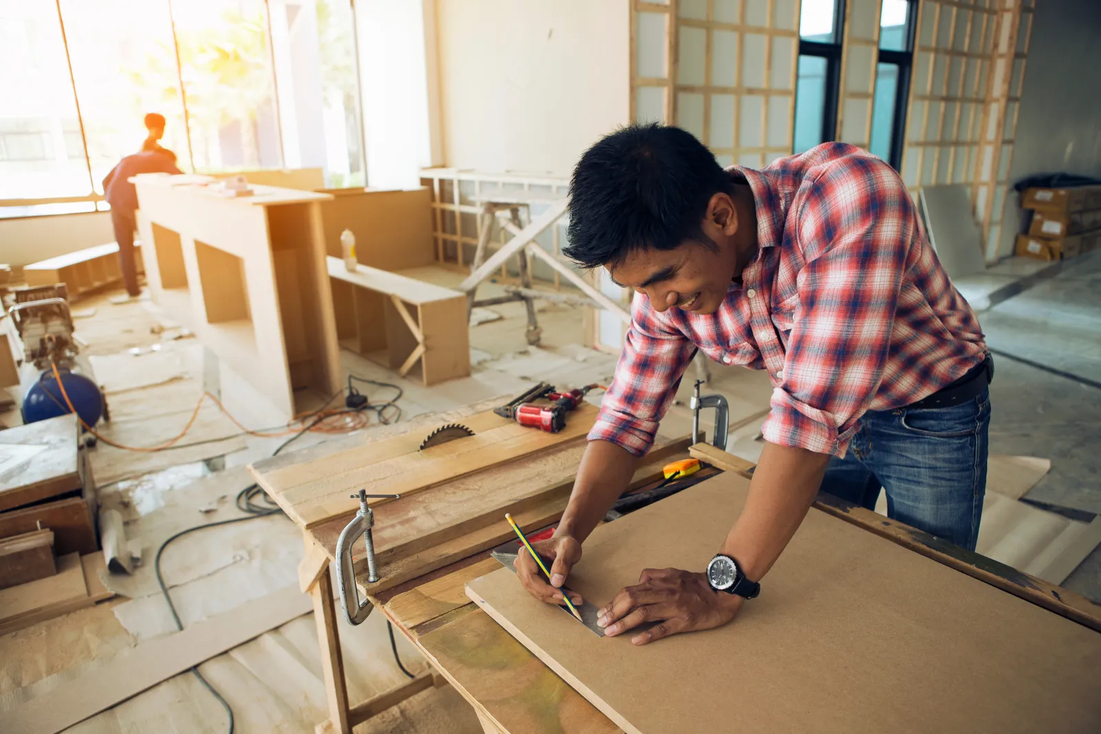 The carpenter is building cabinets on a job site