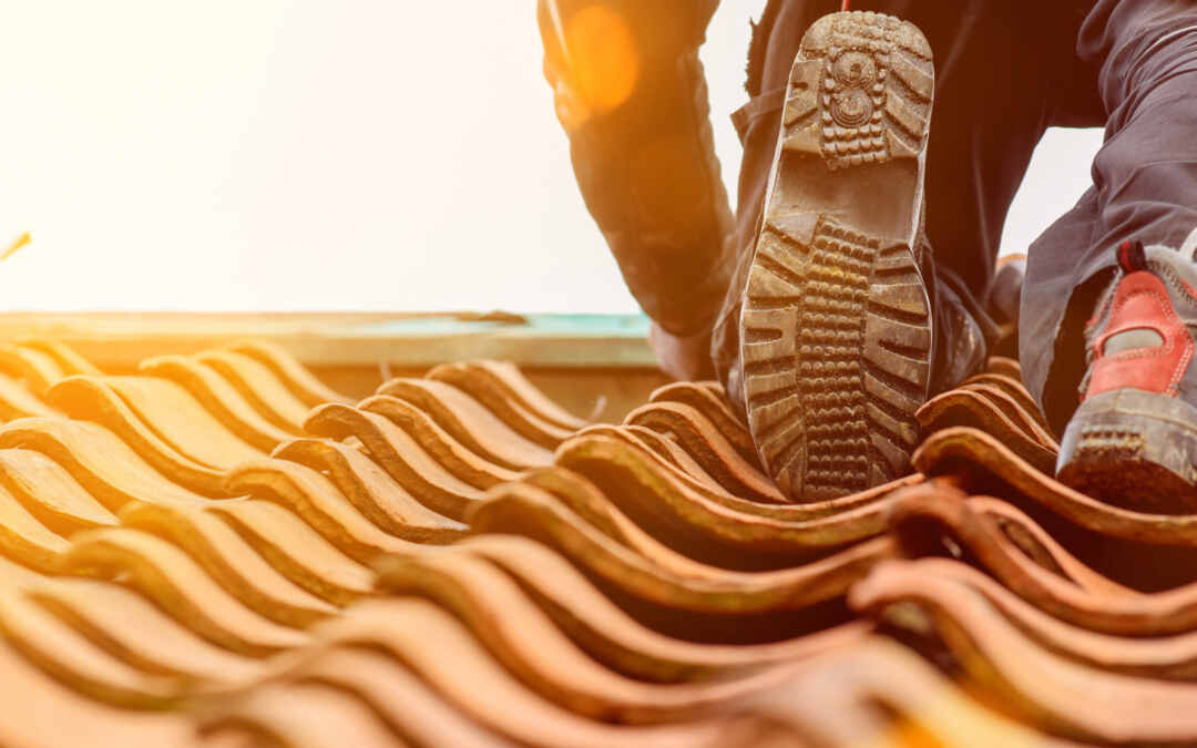 A contractor working on a ceramic tile roof