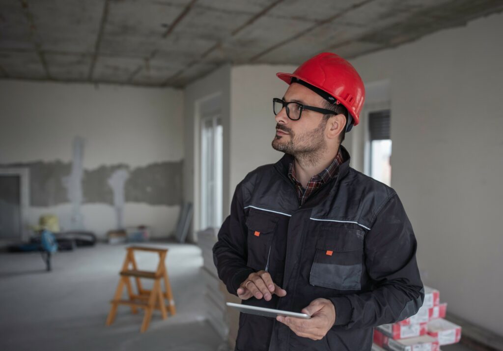 A project estimator on site holding a tablet.
