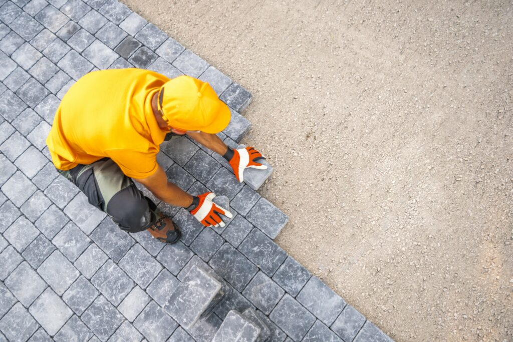 Contractor placing outdoor brick tiles