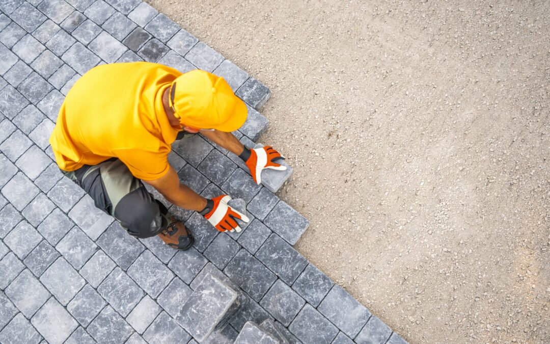 Contractor placing outdoor brick tiles