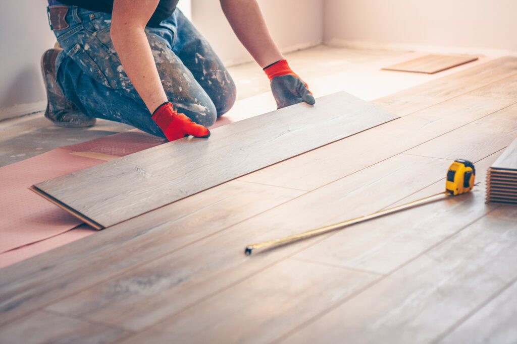 Contractor installing a hardwood floor.