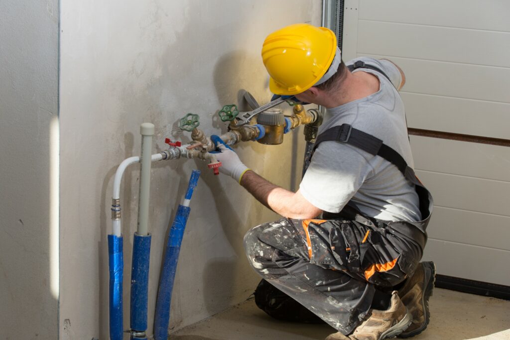 Plumbing contractor working on a job site.