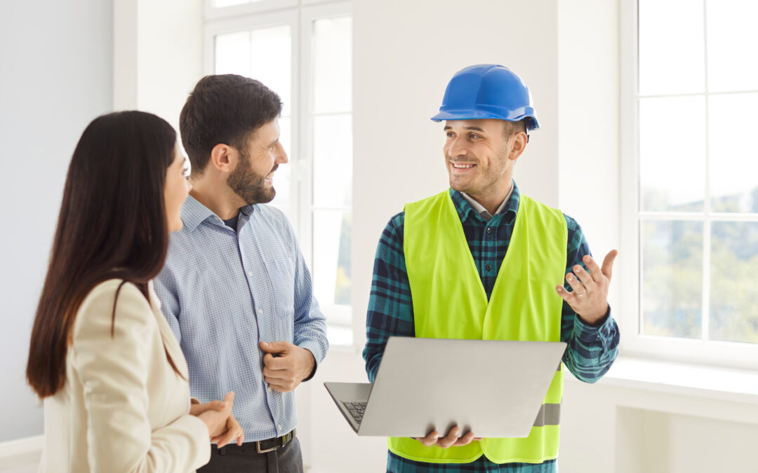 Foreman Discussing Home Renovation Project With Couple Using Laptop