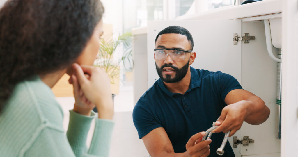 Plumber and client discuss job
