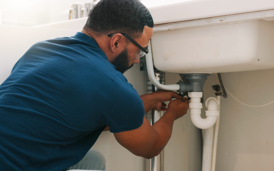Plumber working on a sink