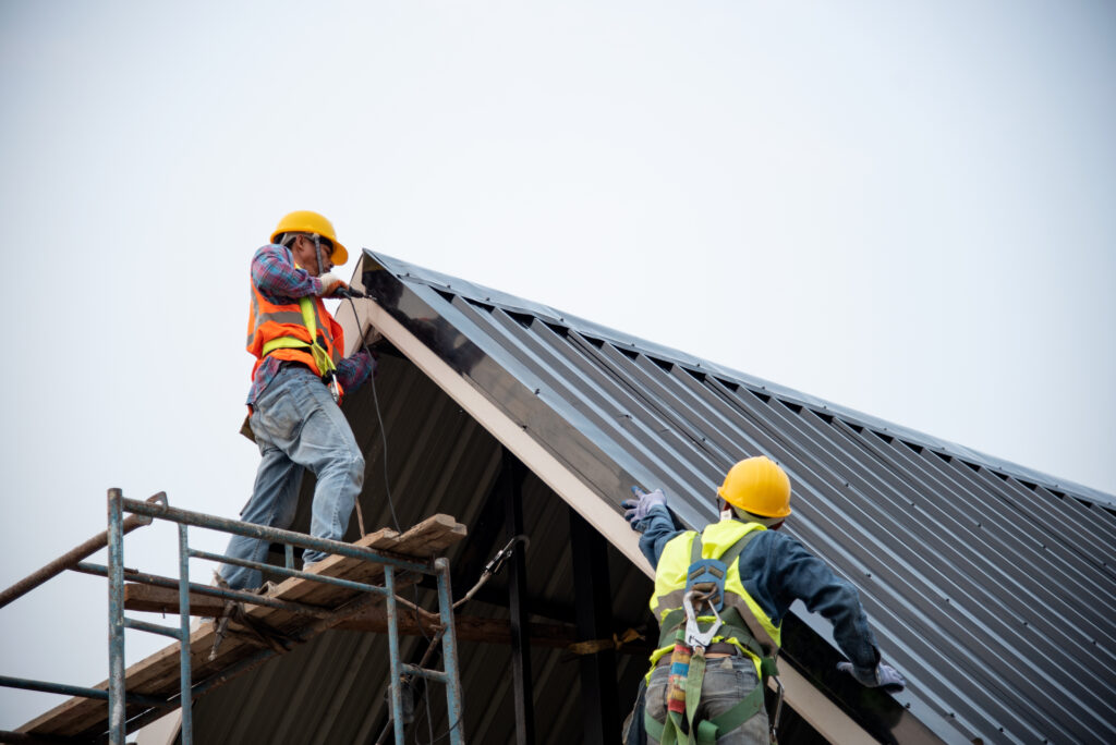 Technician is Work Roof Repair Construction engineer wear safety uniform inspection metal roofing work for roof
